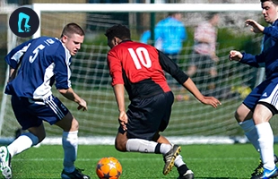 Skilful player displaying exceptional dribbling skills in a dynamic 7-a-side football match